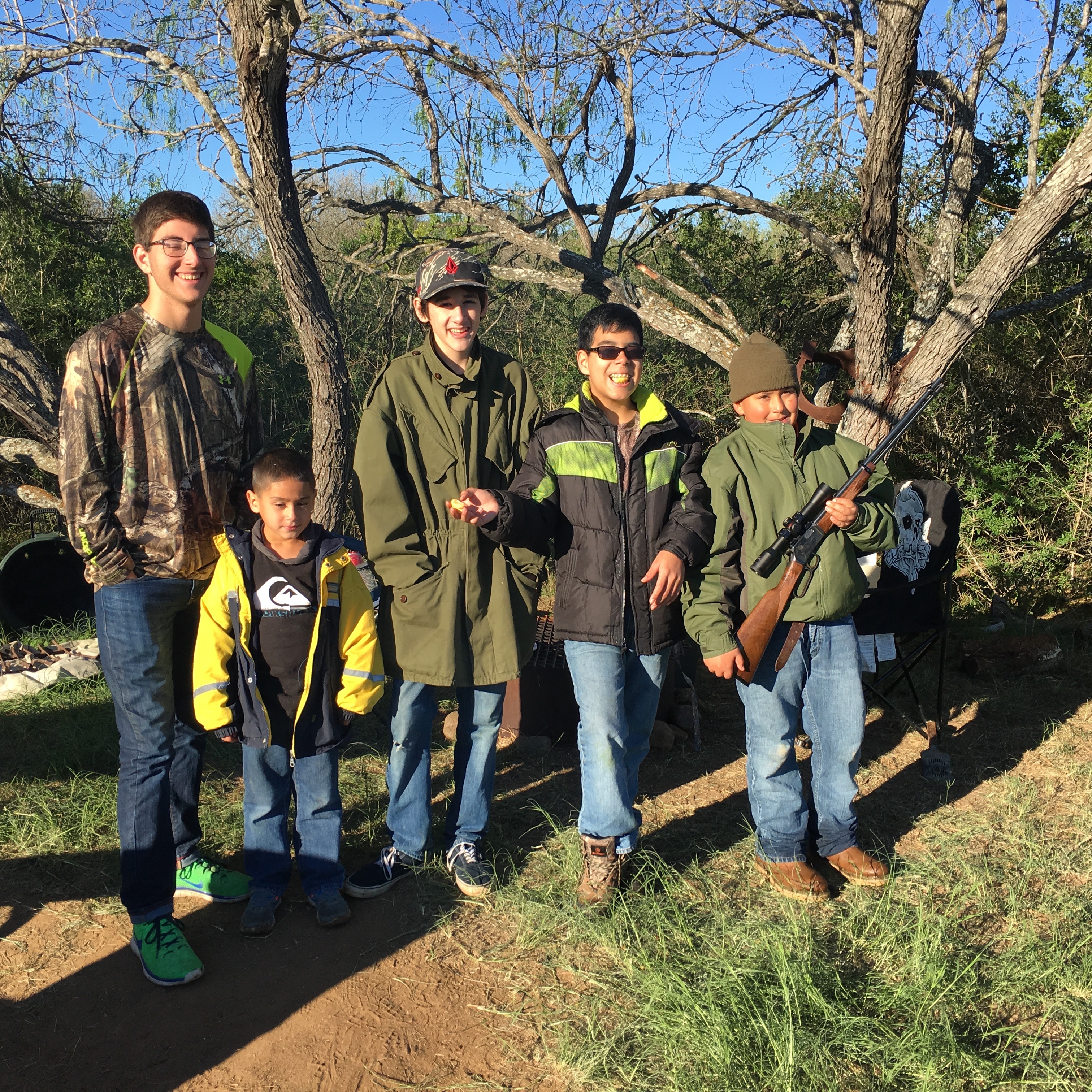 Group of young hunters posing outdoors